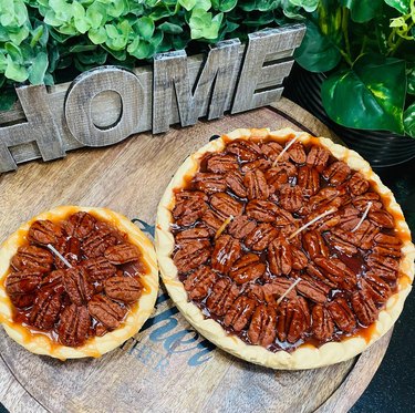 Two large candles shaped like realistic pecan pies