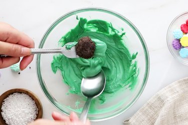 Coat cake balls with melted green candy