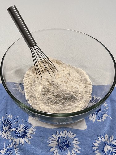 Flour, sugar and salt in bowl with hand-held mixer.