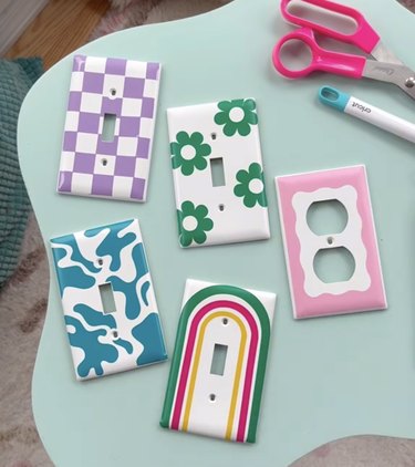 White light switch covers decorated with rainbows, checkerboards, flowers and bright colors