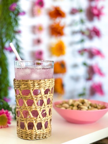 wicker drinking glass with floral wall background
