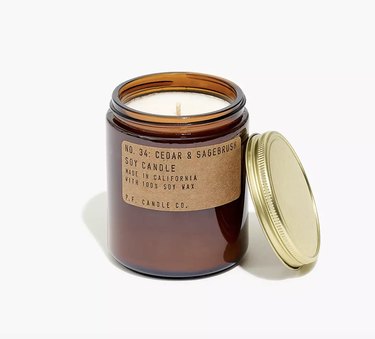 Cedar and sagebrush scented candle in burnt orange glass jar