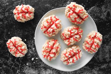 Crispy rice treats shaped like brains with red stringy food coloring