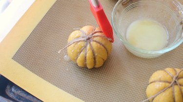 Brushing pumpkin roll with melted butter