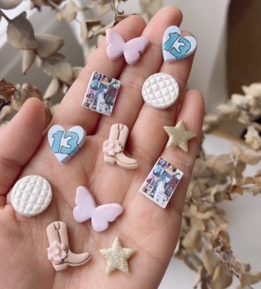Clay charms shaped like hearts, stars, cowboy boots, butterflies, mirror balls and a mini photo of Taylor Swift