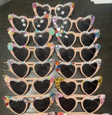Lined-up pinkish sunglasses embellished with beads and jewels