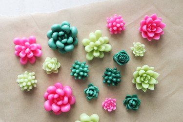 Green and pink wax succulents on parchment paper