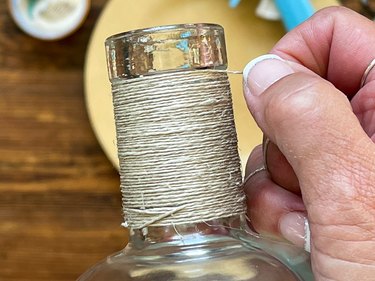 wrap neck of bottle with twine