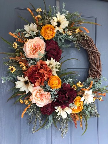 Burgundy Hydrangea Fall Wreath from Etsy. Grapeview wreath with faux greenery and flowers arranged in a C-shape.