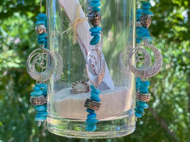 finished message in a bottle wind chimes hanging outside