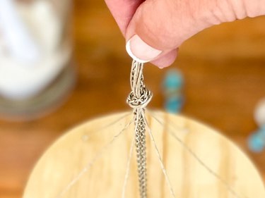 tie a knot in the chain and bead strings