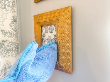 dusting a wall hanging