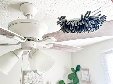 cleaning a ceiling fan with a dusting wand