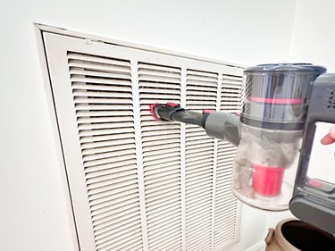 vacuuming an air intake vent