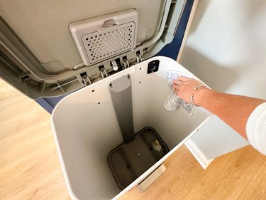 cleaning the inside of a trash can