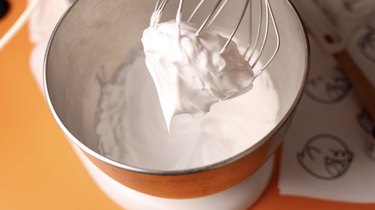 Stiff peak meringue on a balloon whisk.