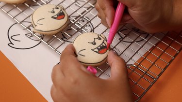 Drawing Boo details with edible markers.