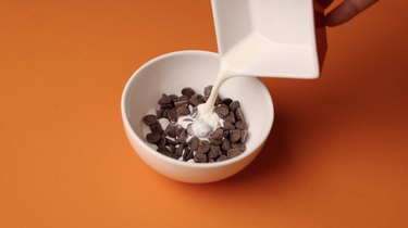 Chocolate chips and heavy cream in a microwave-safe bowl.