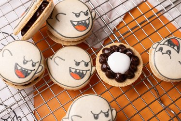 Macarons shaped like ghosts with melted chocolate filling