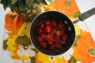 Thawing strawberries in a pot of hot water and strawberry Jell-O