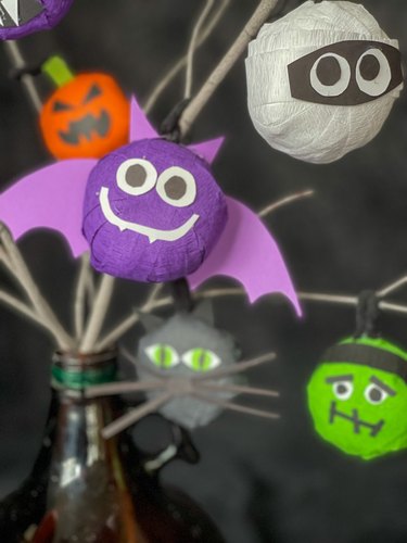 Halloween surprise balls hanging from branches