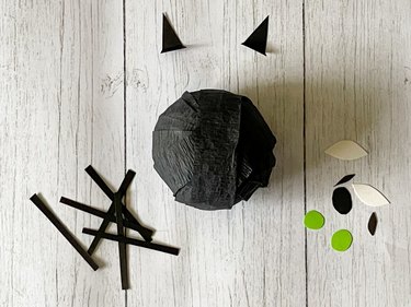 Cut out paper shapes to create Halloween Cat surprise ball