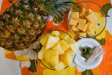 Pineapple cubes, Gouda cheese and green olives paired on a 1970s napkin