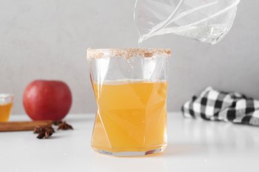 Pouring seltzer and ginger ale into a glass