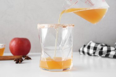 Pouring apple cider into a glass