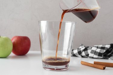 Pouring espresso into a glass cup