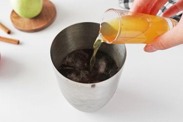 Add barley tea, apple juice and cranberry juice to a cocktail shaker with ice