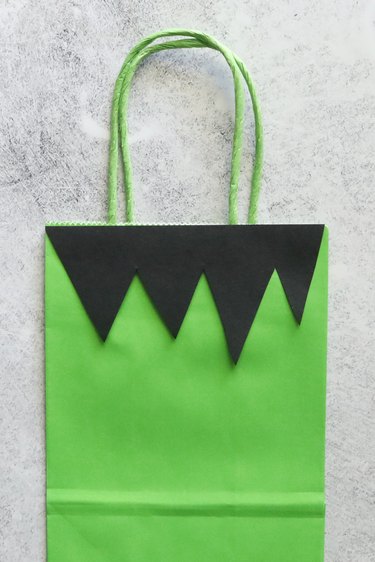 Green paper bag with black hair for Halloween treat bag