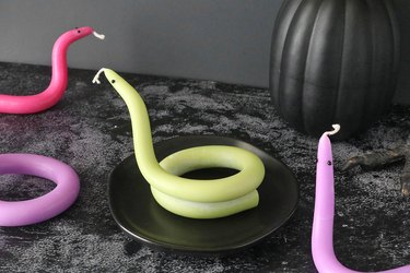 Twisted snake candles on a black background