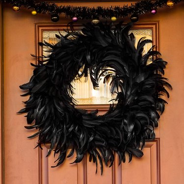Black feather wreath on door