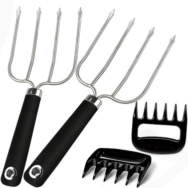 Two stainless steel four-pronged turkey forks with resin handles and a pair of durable plastic meat shredding claws