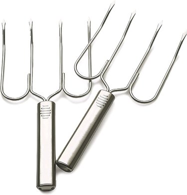 A pair of sturdy four-pronged stainless steel turkey lifting forks