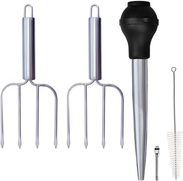Two stainless steel four-pronged turkey forks with a silicone bulb baster, stainless steel marinade injector and cleaning brush