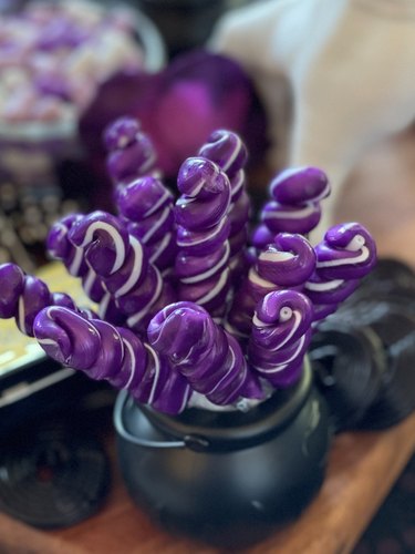 Purple twist pops in a black cauldron