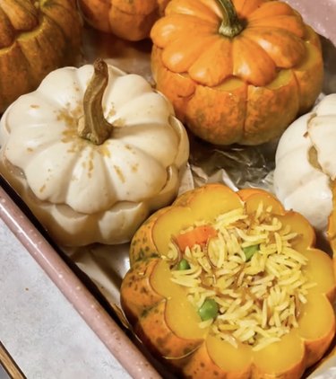 Mini orange and white pumpkins stuffed with rice and vegetables