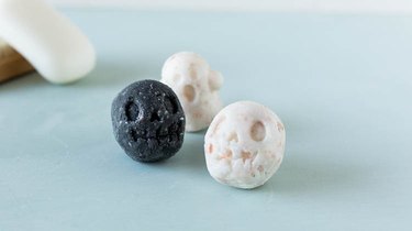 Three bath bombs shaped like skeleton heads