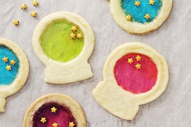 Sugar cookies shaped like crystal balls with bright colorful middles and star candies