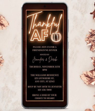 Neon "Thankful AF" invitation on phone