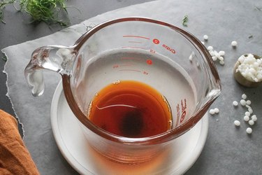 Orange candle dye in a measuring cup