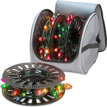 Christmas light storage in gray bag with two wheels inside for wrapping lights around.