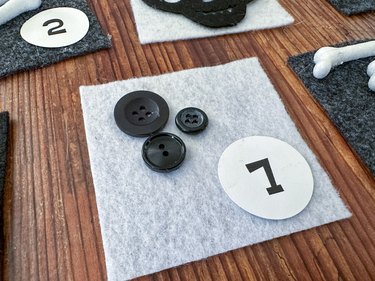 use buttons on white felt squares
