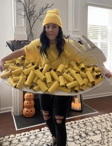 Woman dressed up in a costume shaped like a plate of macaroni and cheese