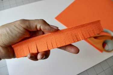 Frayed edges along strip of orange felt