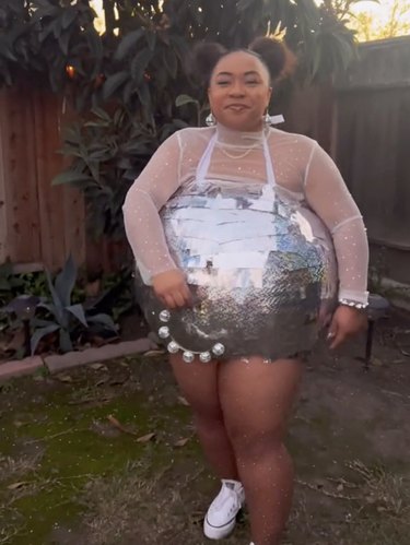Woman dressed up like a silver disco ball