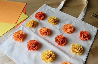 Orange, yellow and red felt marigolds on a tote bag