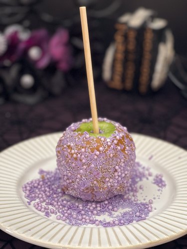 Caramel apple rolled in purple candy sprinkles